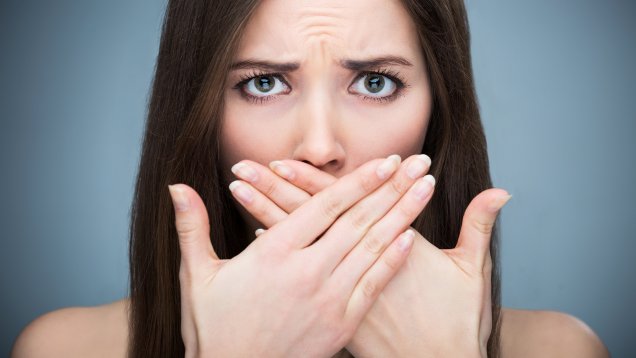 Woman covering mouth
